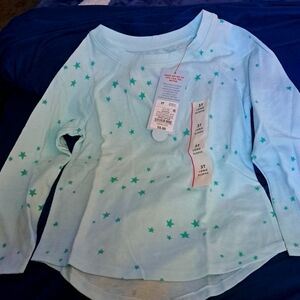 Size 3T long-sleeved shirt. Mint background with green stars all over.